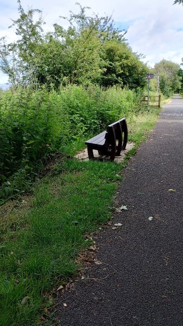 A seat beside a foot path facing the hedge.
Lancashire.