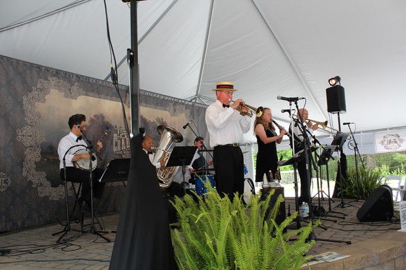 A Dixieland jazz band performs in a tent.