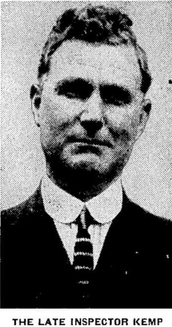 Black-and-white photo: The late Inspector Kemp. 1928. Description: One-quarter headshot of a clean-shaven man in his mid-50s; he is wearing a dark jacket, light shirt with a striped tie. Citation: Evening Post, 26 July 1928, p. 11. https://paperspast.natlib.govt.nz/newspapers/EP19280726.2.57.1