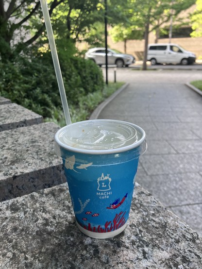 A cold beverage cup with a straw labeled 