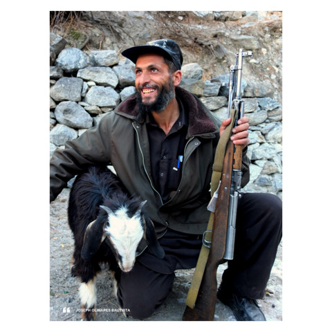 A photo of a cheerful security escort and his rifle- and a goat by his side. Photo taken in 2013 by Joseph Bautista in Gilgit-Baltistan, Pakistan.