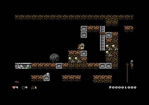 The image depicts a classic 8-bit video game scene featuring a character in a cave setting. The character is surrounded by blocks, a boulder, and ladders, with various collectible items and enemies visible. The UI displays health, score, and