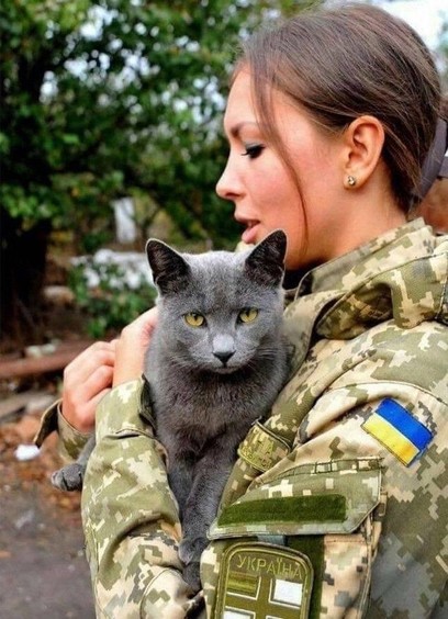 Female Ukainian soldier saving a cat